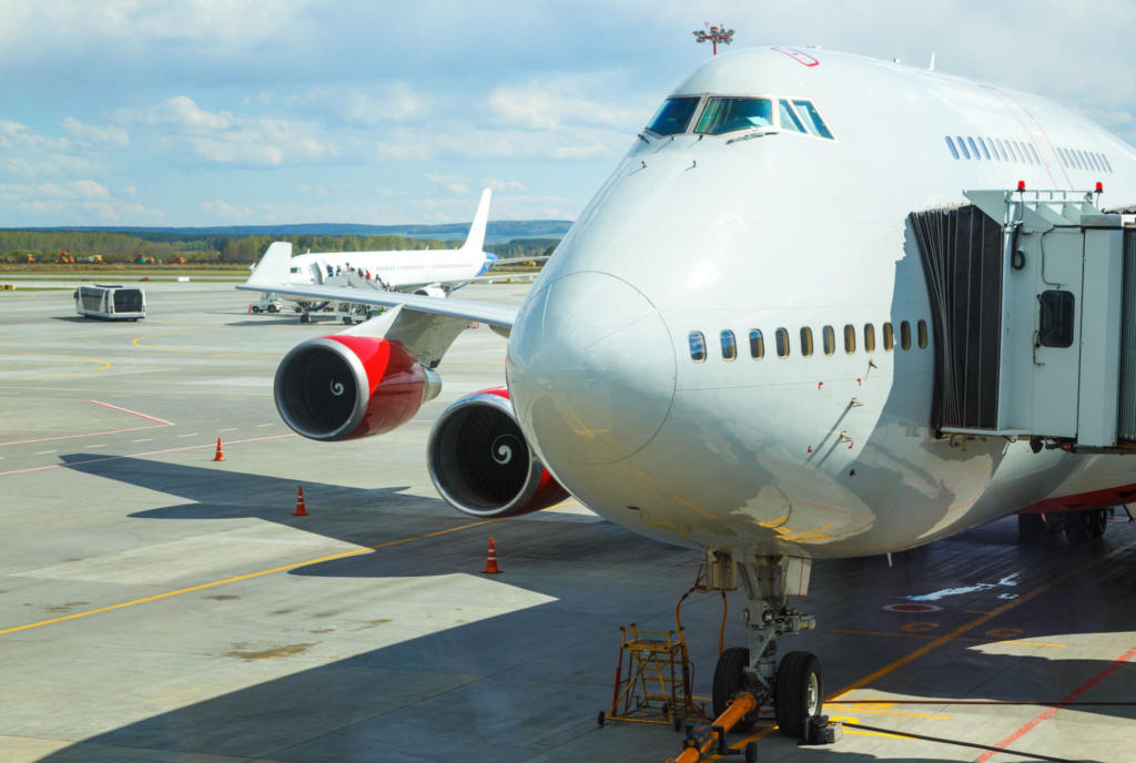big passenger airplane is landing to runway of airport 