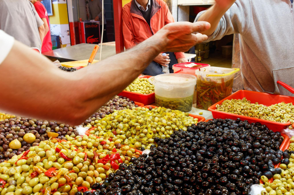 Market scene in Oran, Algeria. people exchanging money over food.