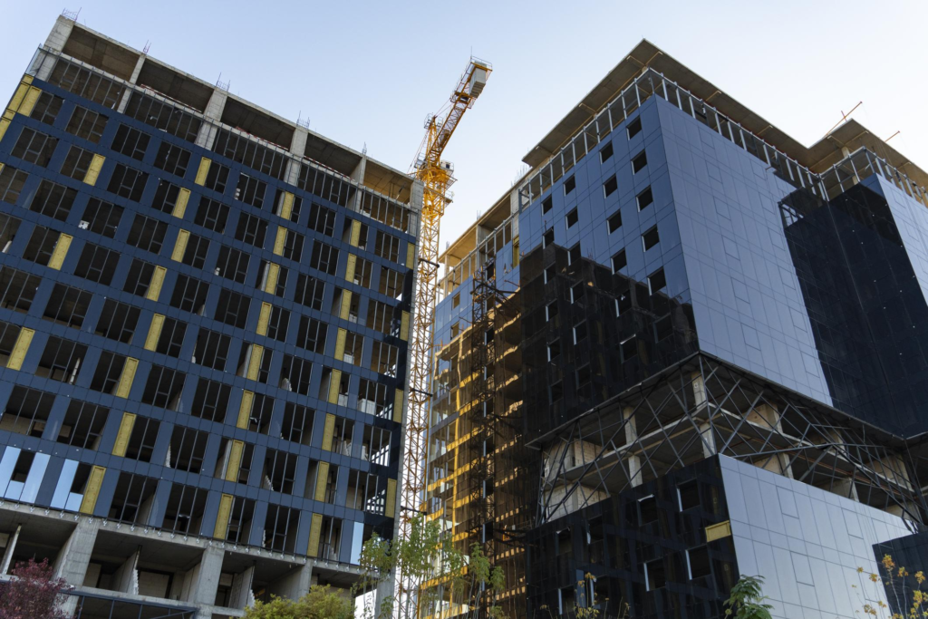 Modern High-Rise Buildings Under Construction with Tower Crane in Uzbekistan 