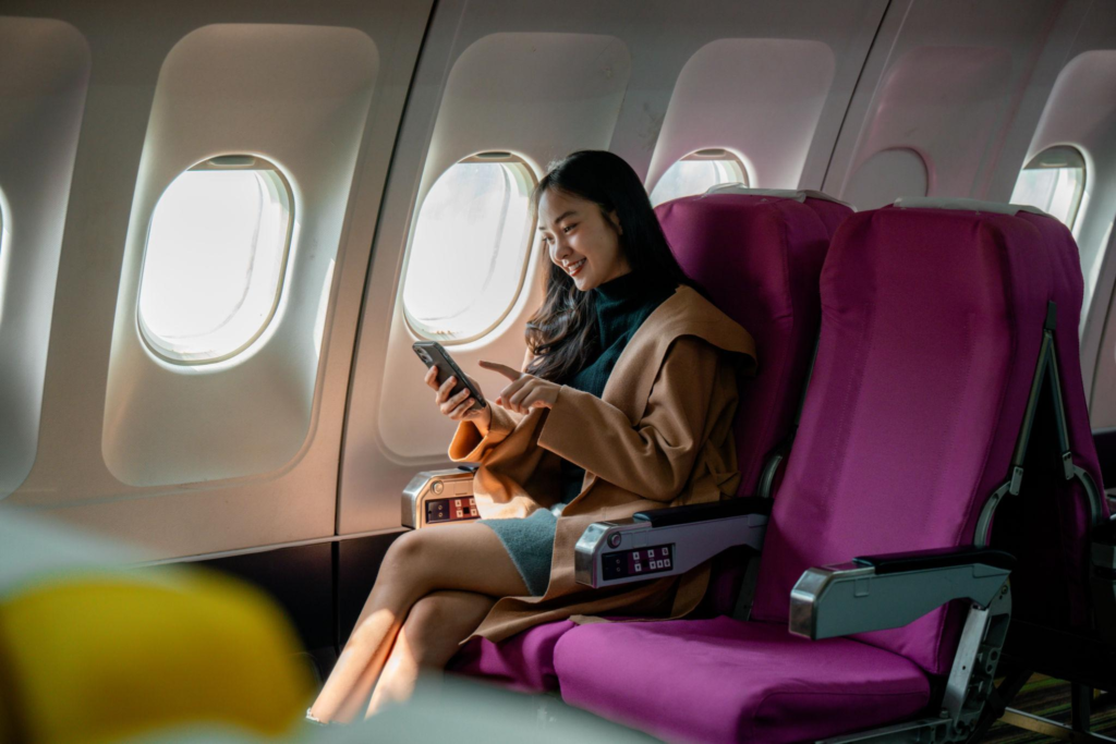 Passenger using mobile phone during flight