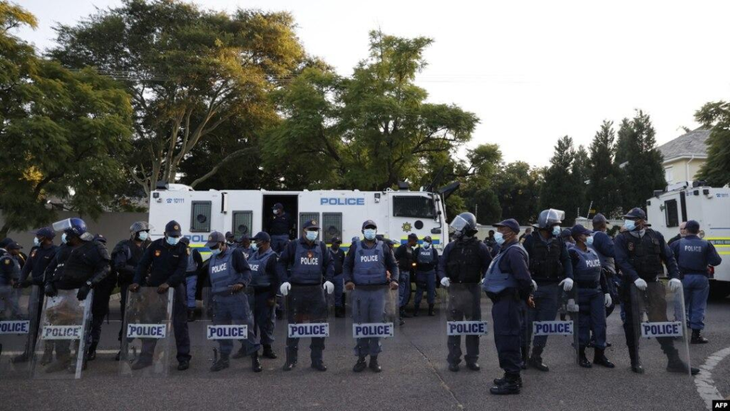 Police task force standing with their riot shields