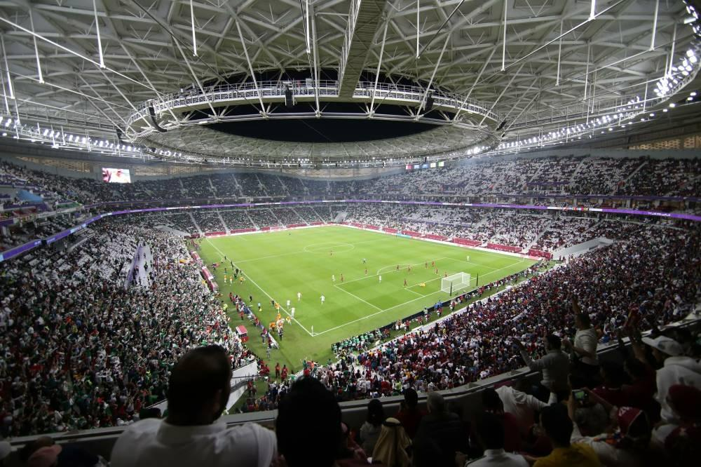 Fans inside a packed football stadium during World Cup atmosphere