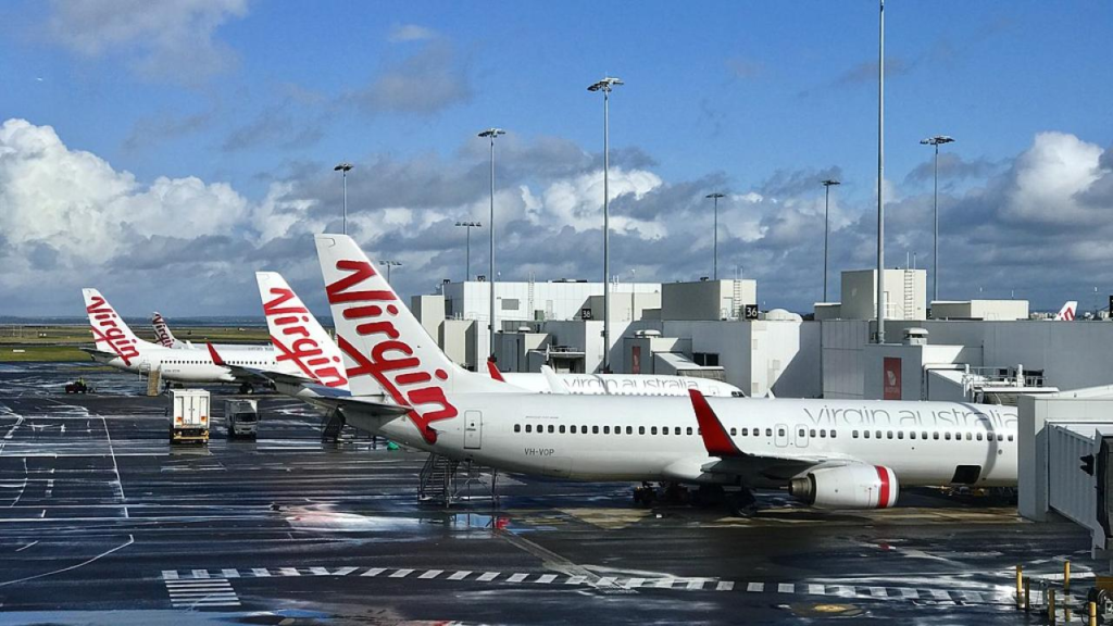 irgin Australia passenger aircraft on the tarmac ahead of the June 2026 flight credit deadline.