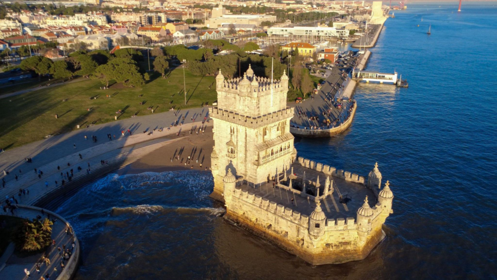 Aerial view of the ornate stone Belém Tower standing in the Tagus River along the Lisbon waterfront